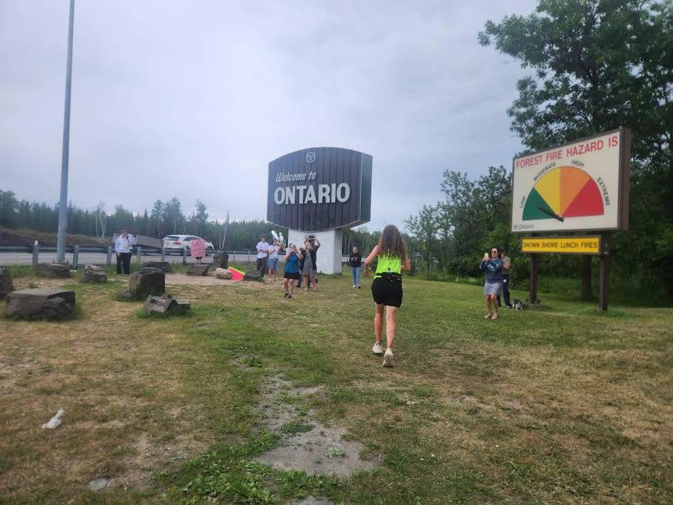 Diane Wing arriving at the Ontario border after starting her run in Saskatchewan 10 days ago. Submitted Photo/Diane Wing