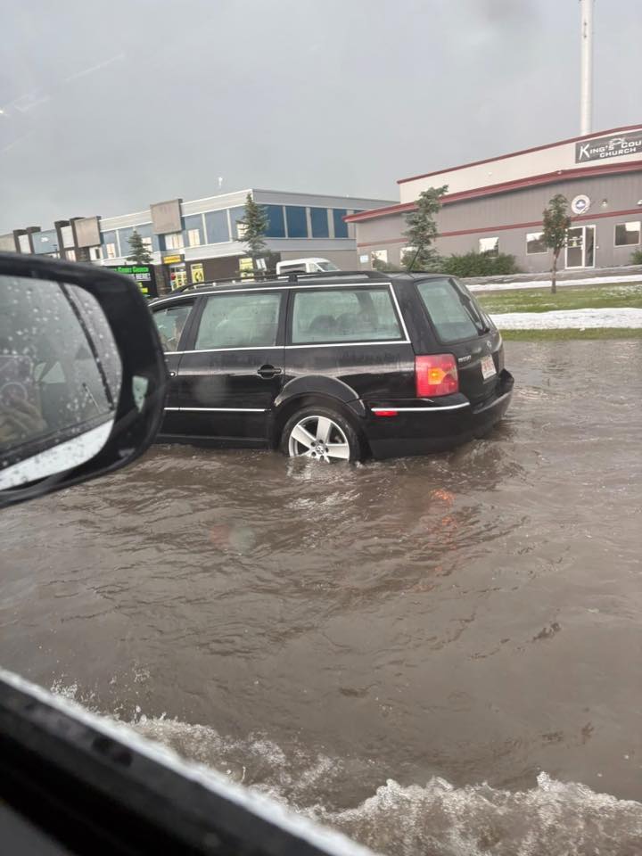 A vehicle navigated deep water on an Airdrie street during Thursday’s storm. Ask ChatGPT