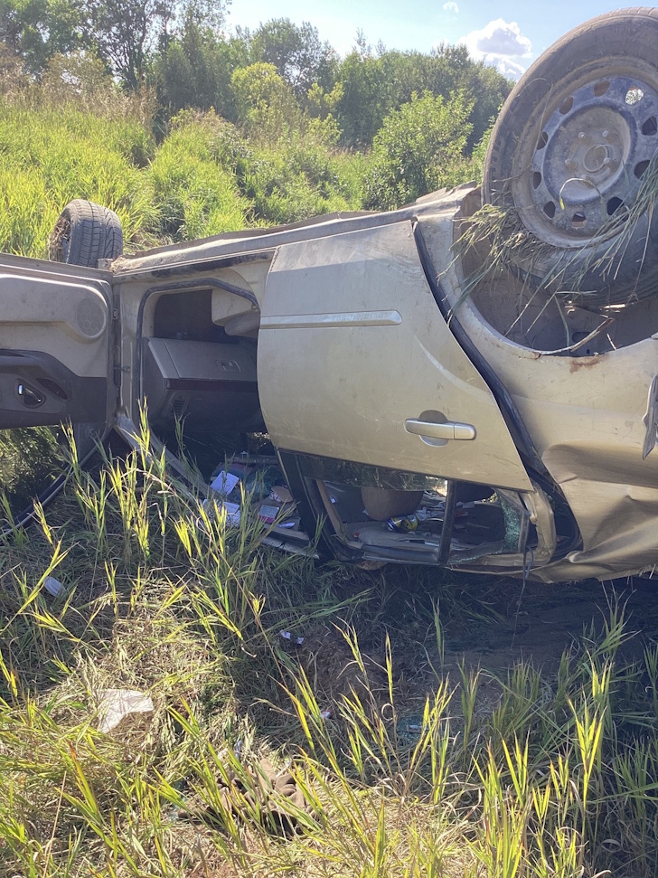 A close-up view of the overturned sedan involved in a rollover near PR 352 and Road 68W yesterday, prompting a search for five individuals seen fleeing the scene. Submitted Photo/Austin MB Fire Department