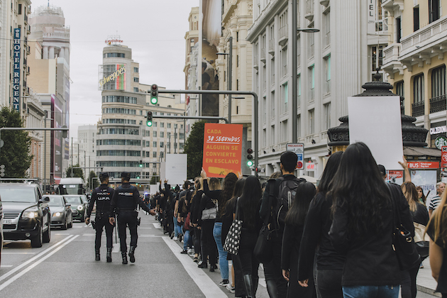 hundreds of people lined on the street marching