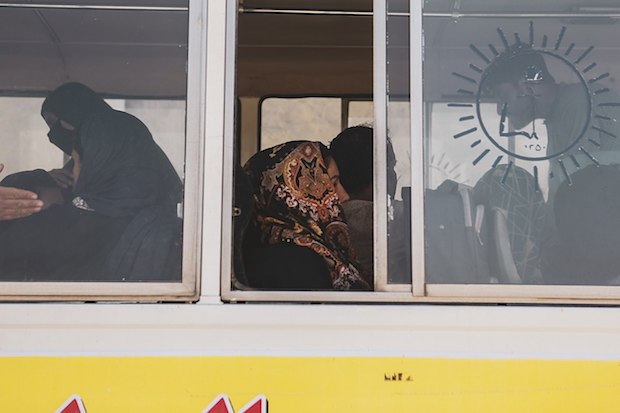 A woman is seen sitting on a bus