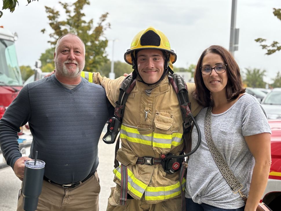 Firefighter Seth with his parents after completing the stair-climb.