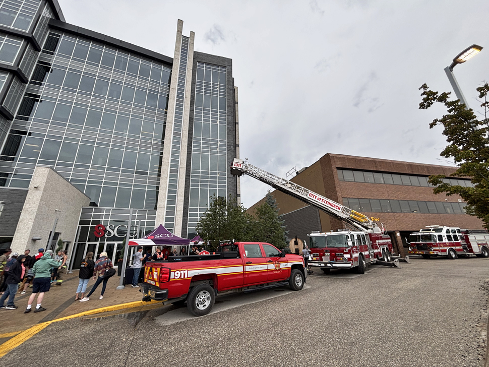 Steinbach Fire Department trucks parked on the east side of the Steinbach Credit Union building.
