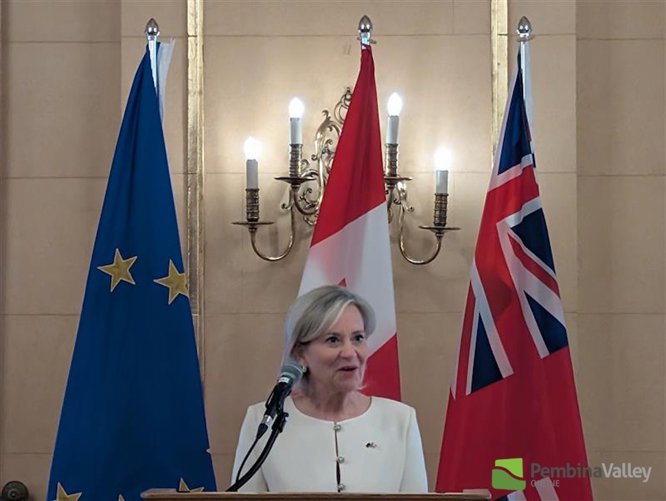 a woman speaks at a podium