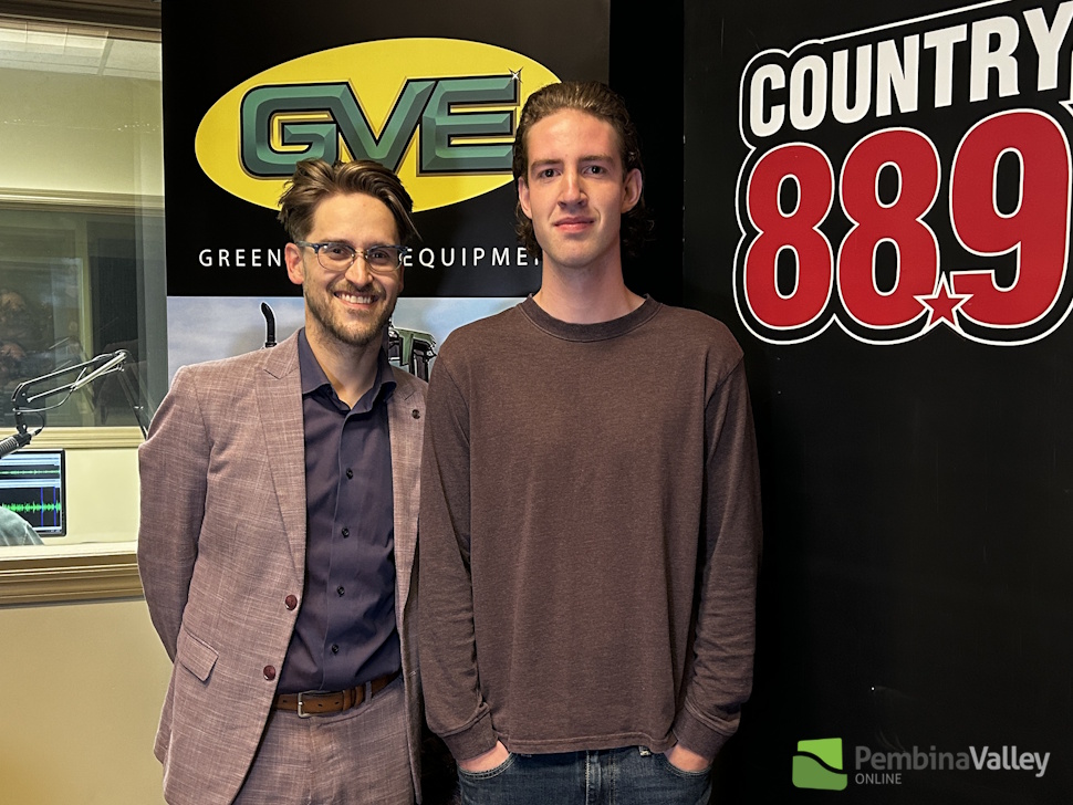 two men stand in a studio