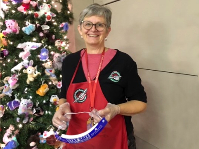 Ina Reimer with her protective gear at the Landmark Shoebox Store (2020)