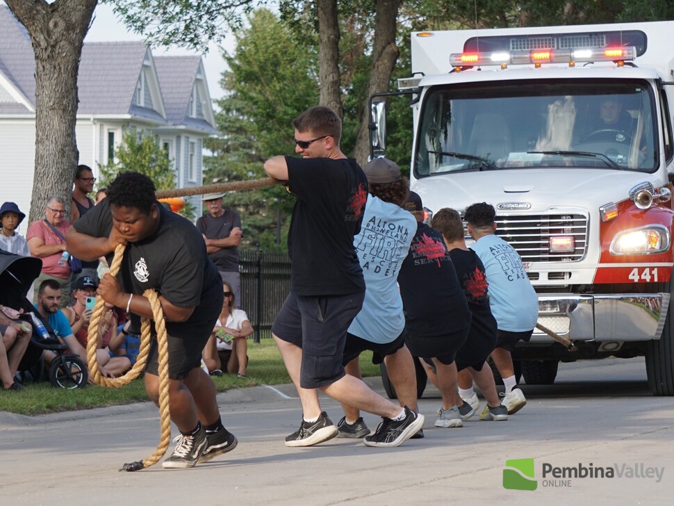 A team pulls a firetruck during the annual fire truck pull