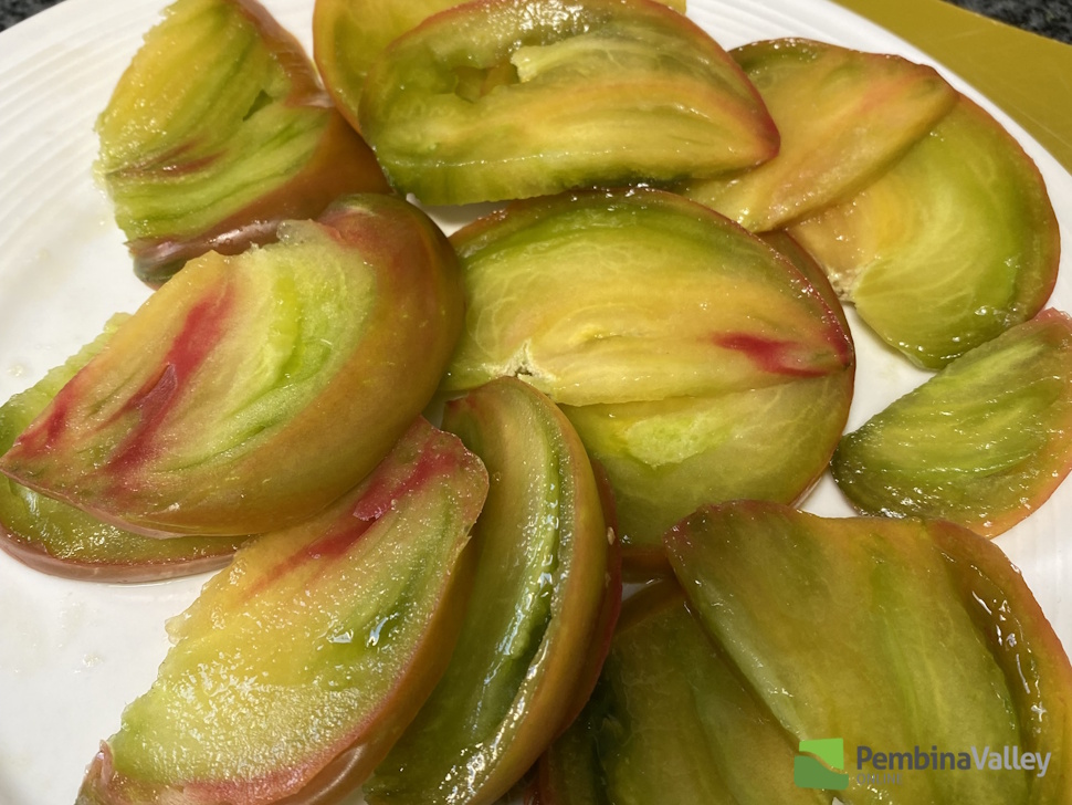 a sliced green and red tomato