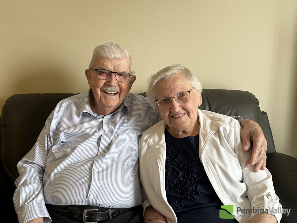 a couple sits and smiles together