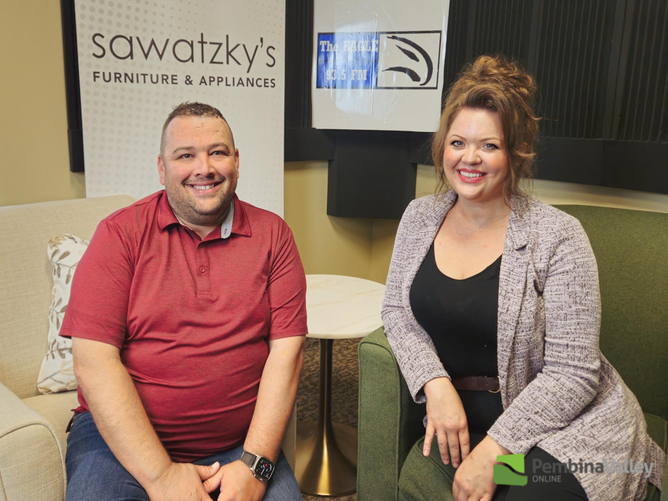 two people sit in a studio