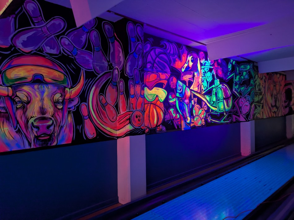 The Southport Bowl mural glowing with the help of a black light