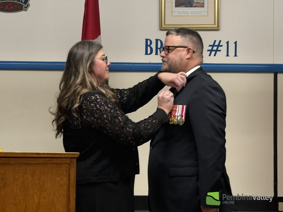 LTC Mark Wilson, (right) receiveing Coronation Medal from Morden/Winkler MLA Carrie Hiebert