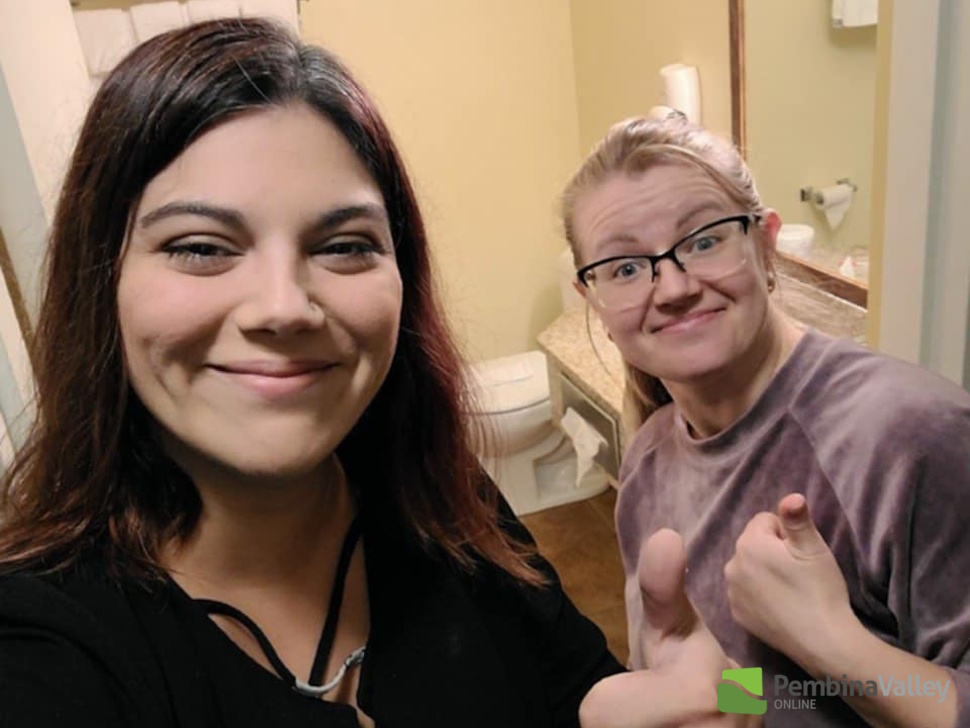 two staff members smile in one of rooms at Quality Inn