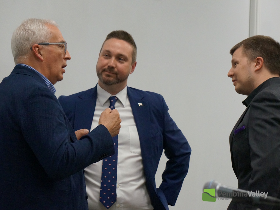 Robert Kreis, Branden Leslie and Kevin Larson talking to each other during Wednesday's forum