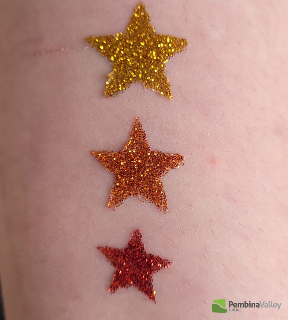 a glitter tattoo in the shape of stars