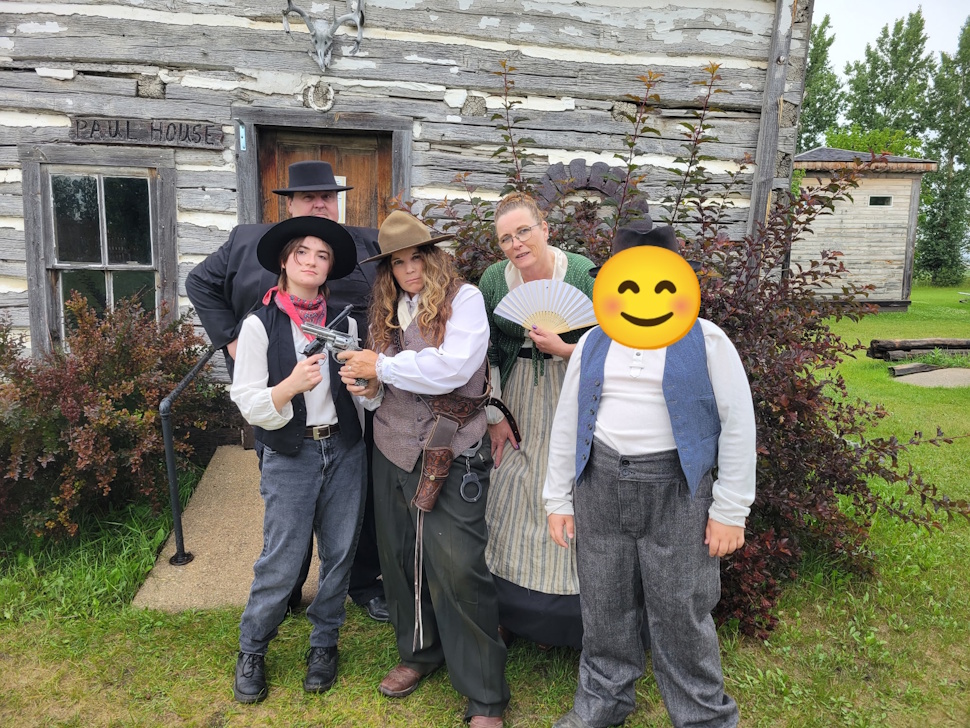 Cast members of The Murder of Gold Toe Jake pose after a show at Fort la Reine Museum. From left: Chris Kitchen, Caitlyn Dion, Cindy McDonald, Tammy Roberts, and a young local who joined the acting fun. Submitted Photo/Emma Ens-MacIver