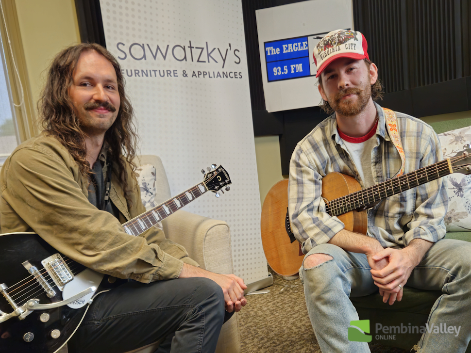An Unexpected End duo sitting in the radio station chairs