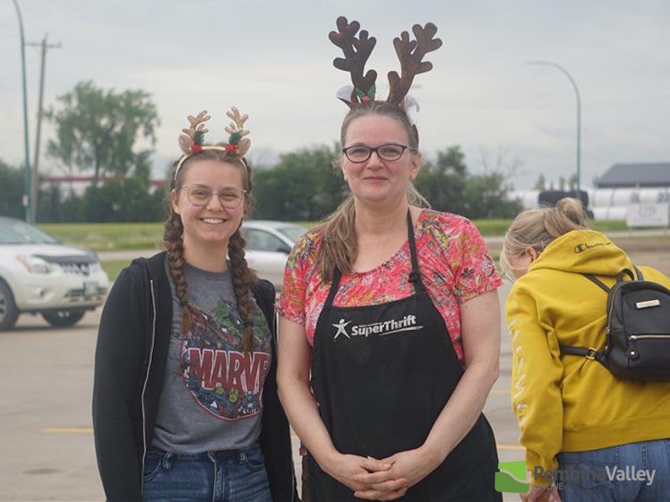 two people wear reindeer antlers