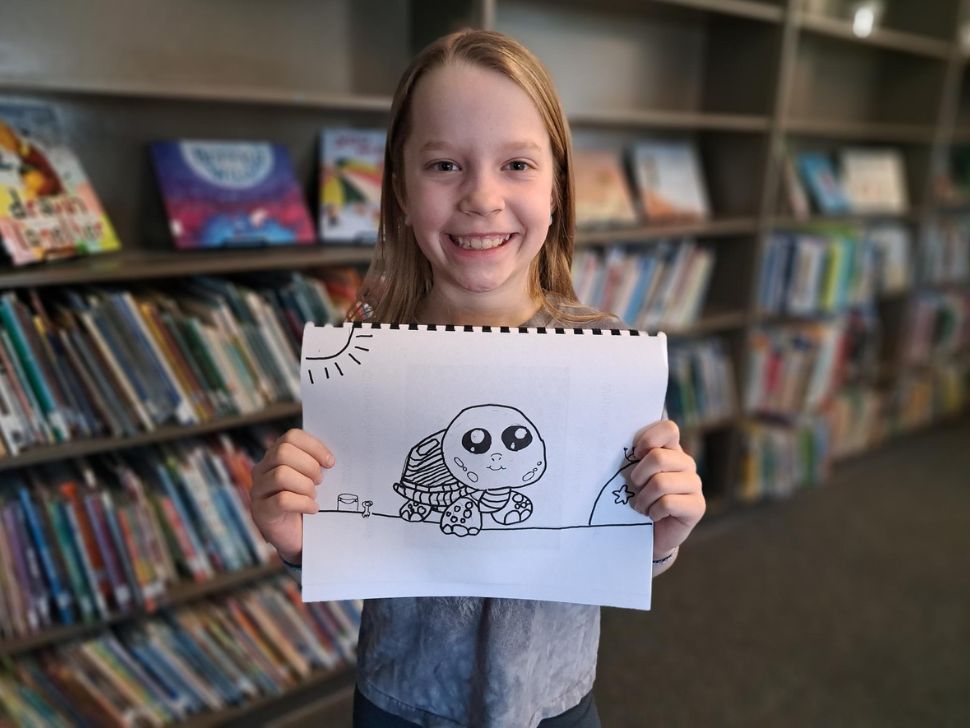 Kingsley holds her drawing 