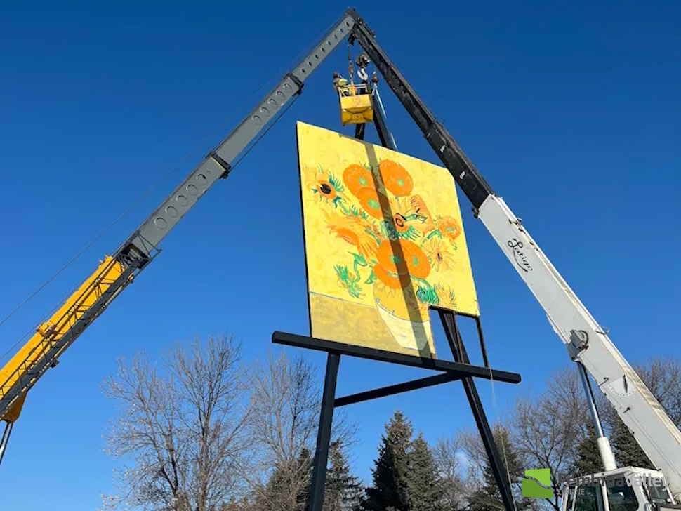 Crews taking down the damaged painting. (Submitted photo)