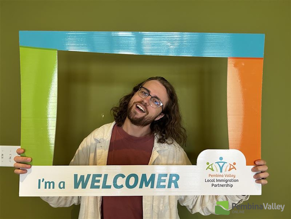 a person stands in a welcomer frame