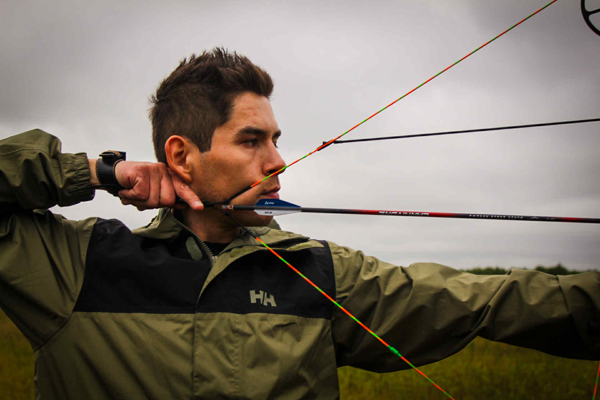 close-up shot of Justin Lilley, drawing his bow, ready to strike at his next harvest.