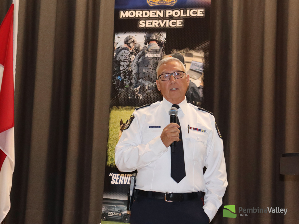 Chief Brad Neduzak speaks to the crowd at his retirement open house