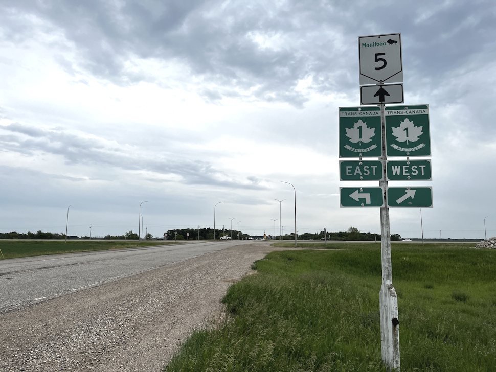 Photo taken from the north on Highway 5 showing the road sign for the intersection with the Trans-Canada Highway near Carberry, Manitoba.
