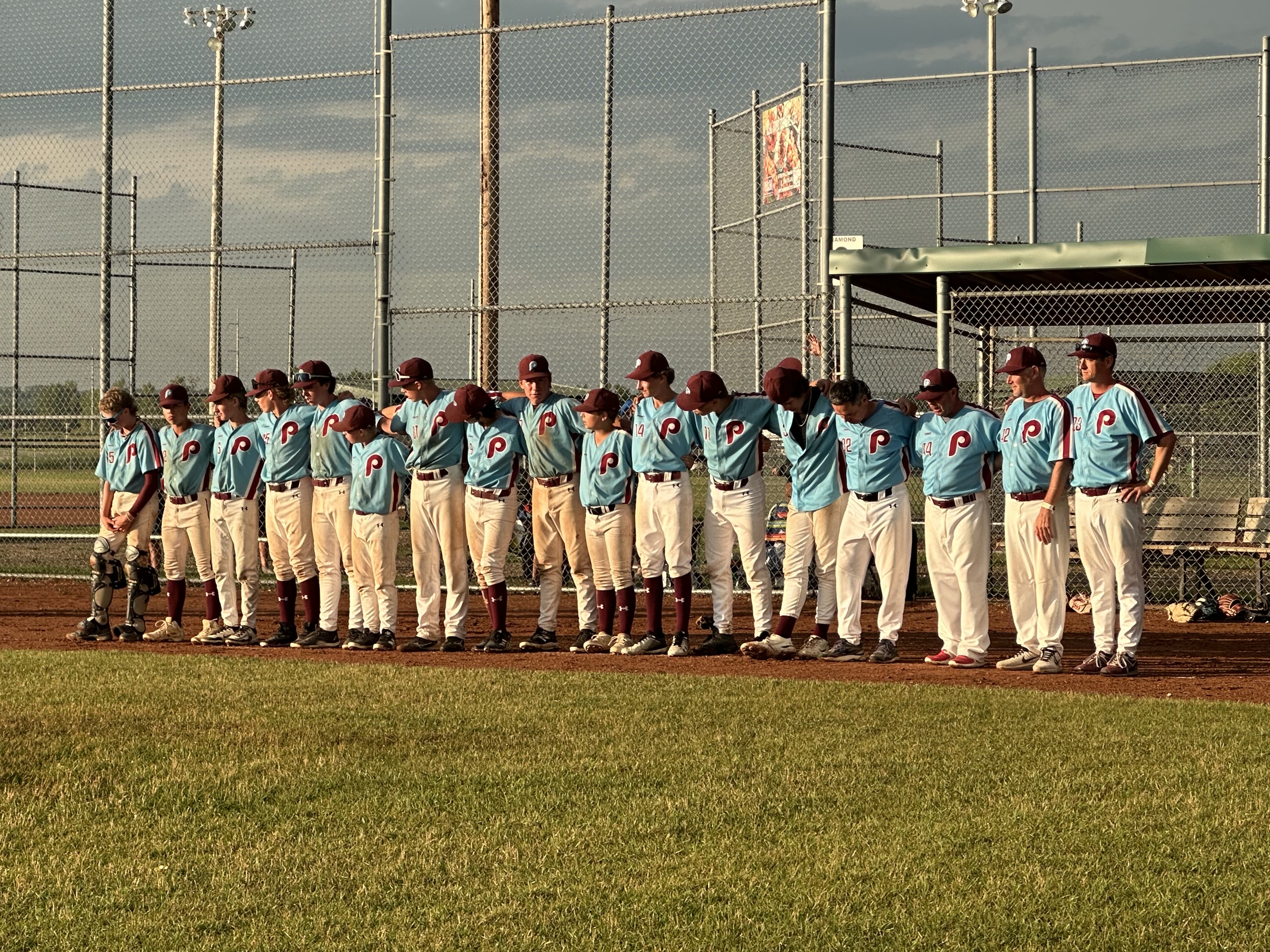 The Phillies stand shoulder to shoulder after the game, as they wait for the official announcement of their victory.