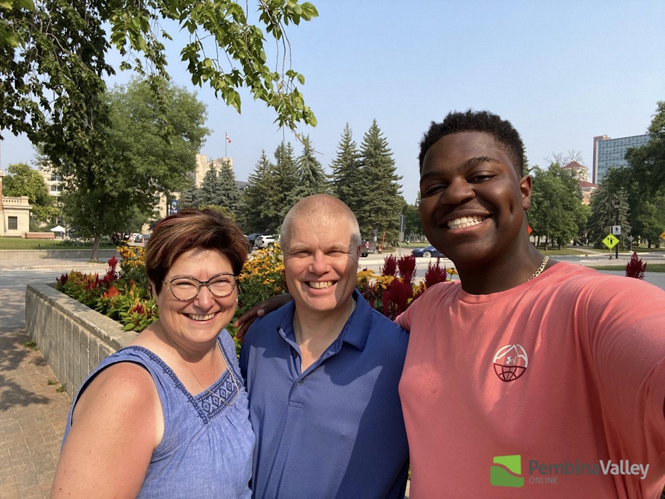 three people pose in a photo 