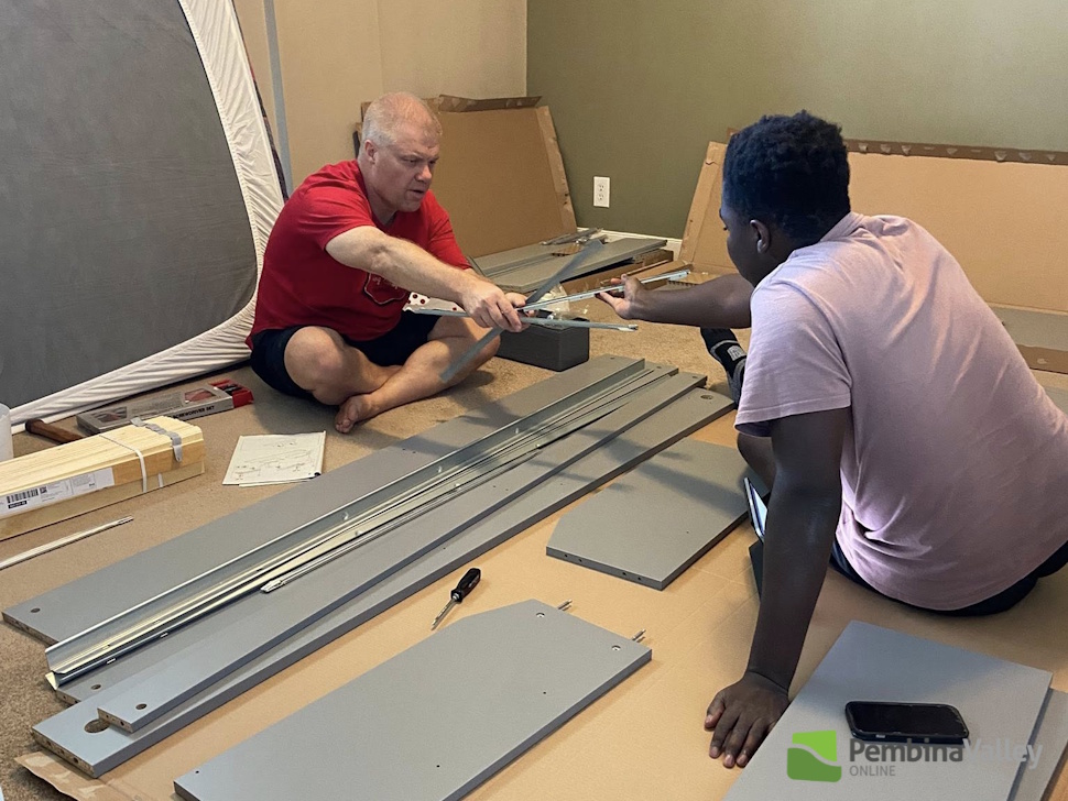 two people assemble furniture 
