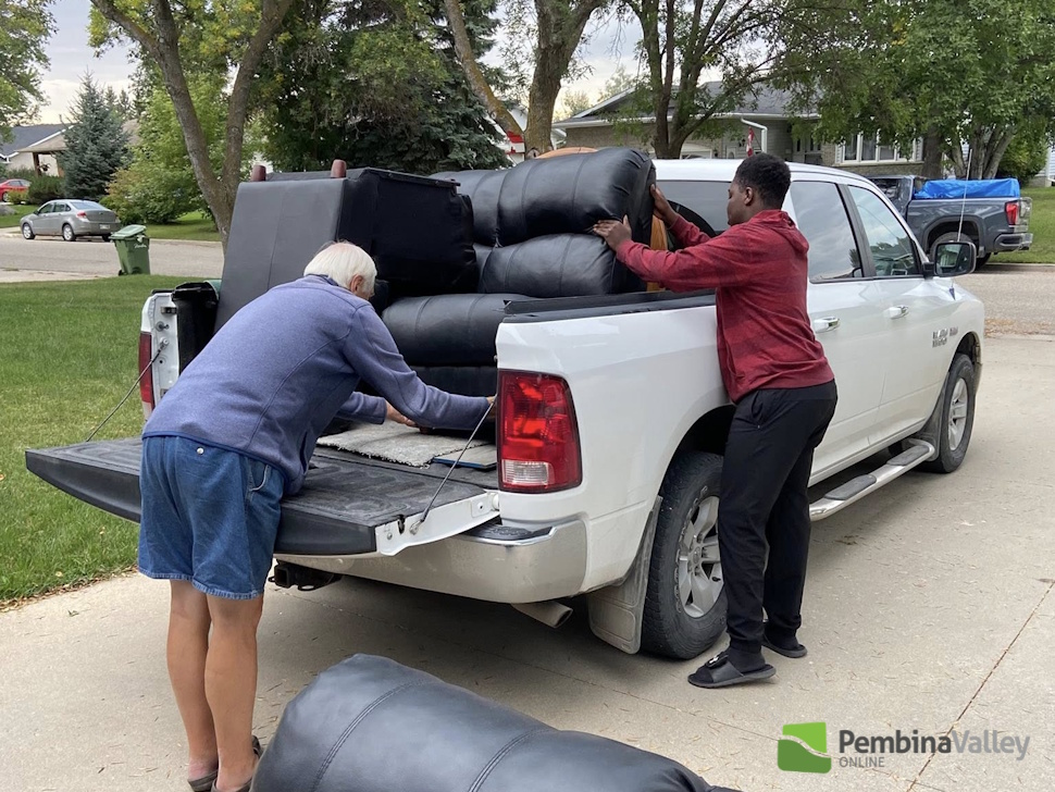 two men load a truck