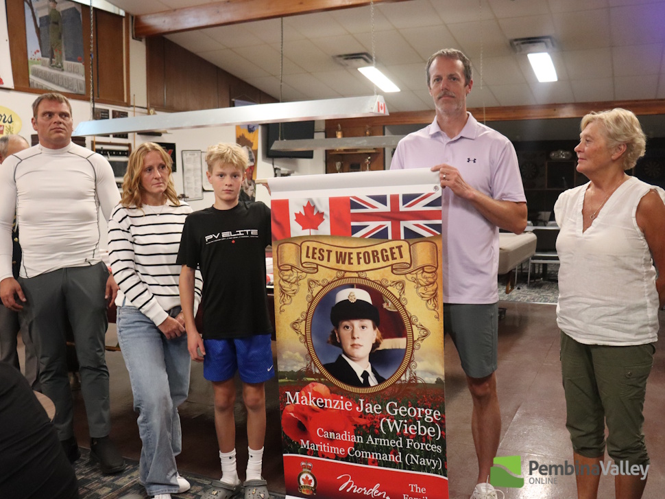 a family stands around a banner