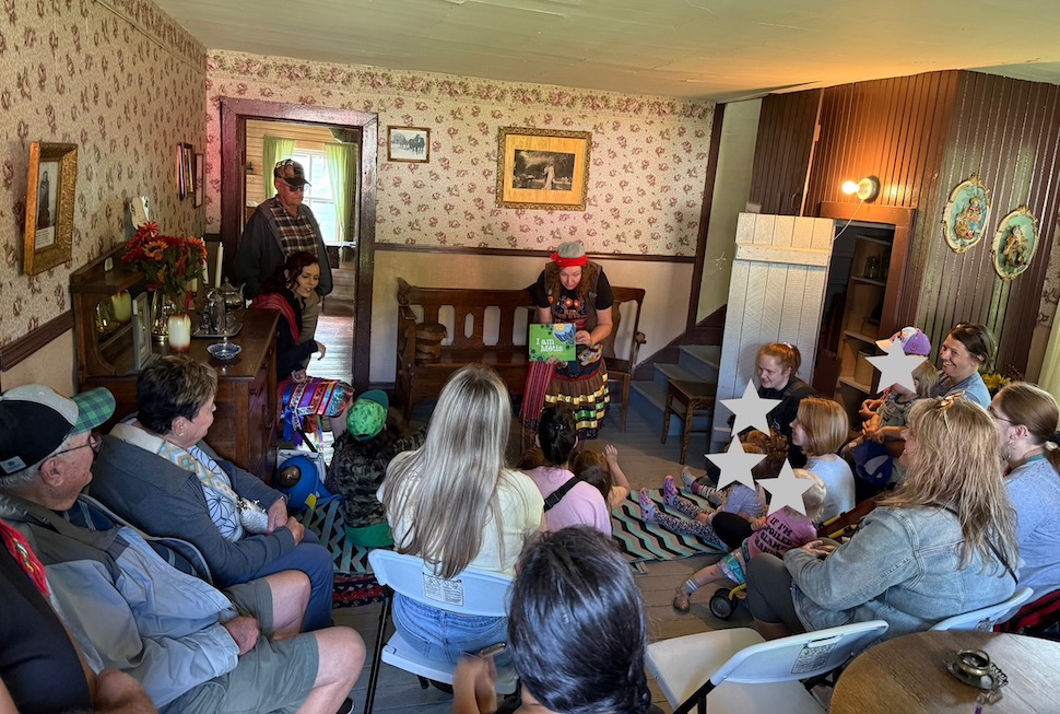 Métis author Karen Hourie Ellefson reads to a group of children inside the Hourie House last week, as part of Fort la Reine Museum’s summer reading program. Submitted Photo/Emma Ens-MacIver
