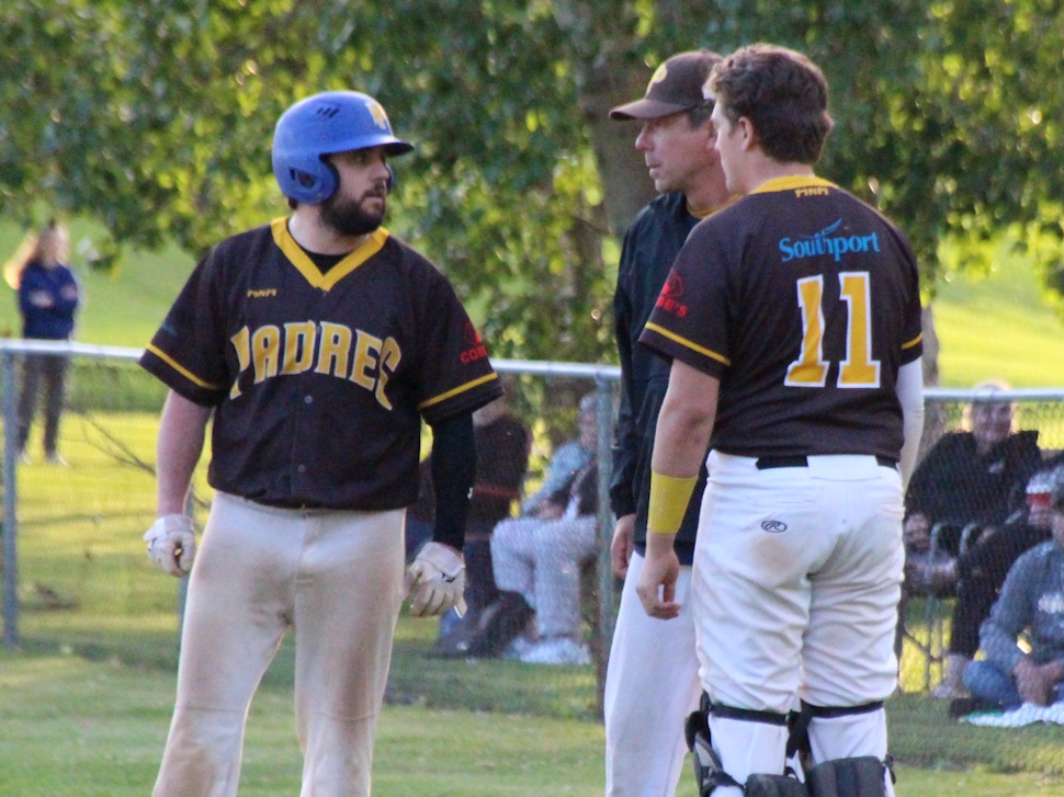 Padres manager Andrew Moar talks with his players on the field after Game 5 of the SCBL championship.