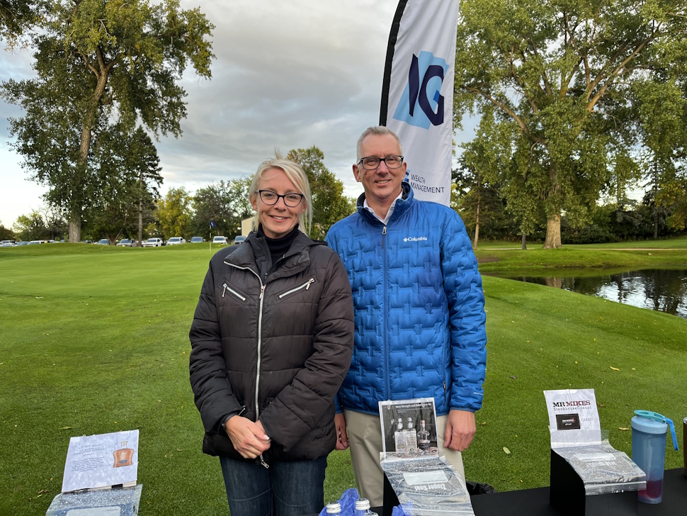 A sponsor table at the Sip and Stroll event, featuring raffle draws and promotional materials from local businesses.