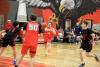 A basketball game between teams in dark blue and red