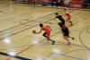A basketball game between teams in dark blue and red