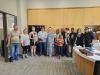 The group stands for a group photo with Mayor Knox in her office