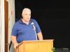 a man stands behind a podium