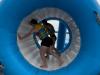 people stand in an inflatable tunnel 