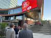 A WIDE ANGLE SHOT SHOWS TRUE NORTH SQUARE AND THE CHVN LOGO ON A LARGE OUTDOOR SCREEN
