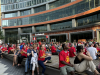 A LARGE CROWD SITS AND LISTENS TO A SPEAKER